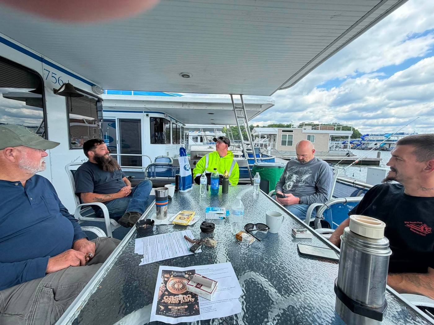 A group of veterans gathered at the dock among houseboats before a weekend trip.